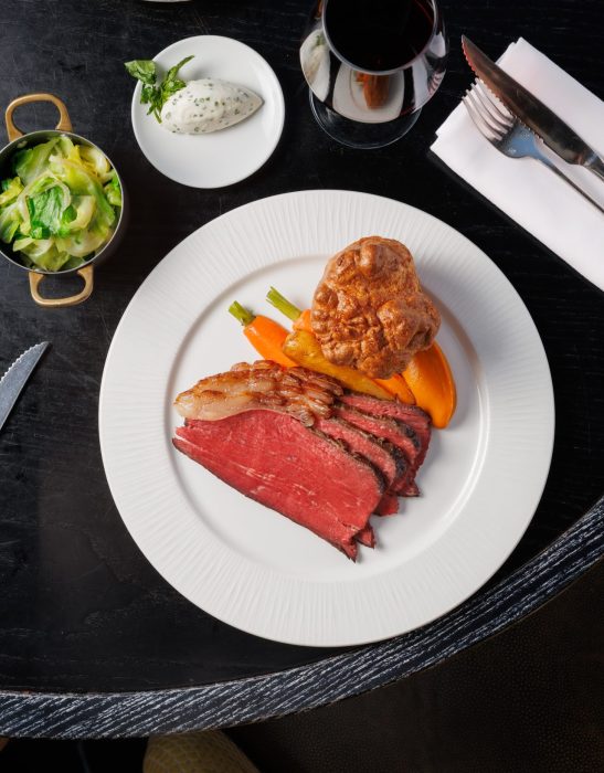 Choose from three Sunday favourites: Roast Rump of Hereford Beef with horseradish cream and red wine sauce, Suffolk Corn-Fed Chicken with bread sauce and gravy, or a hearty Nut Roast served with vegetable gravy. Each roast is served with seasonal heritage carrots, parsnips, spring greens, crispy roast potatoes, and a golden Yorkshire pudding – because no Sunday is complete without one.
Choose to add on all your favourite sides such as Cauliflower Cheese, Green Beans with wholegrain mustard, and Truffle and Parmesan Fries to craft the ultimate roast experience.
